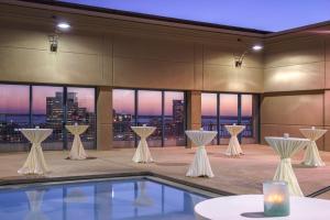 a room with a pool and a view of a city at Hyatt Regency Jacksonville Riverfront in Jacksonville