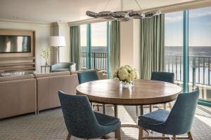 a living room with a table and chairs and a couch at Hyatt Regency Jacksonville Riverfront in Jacksonville