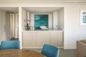 a living room with a table and blue chairs at Hyatt Regency Jacksonville Riverfront in Jacksonville
