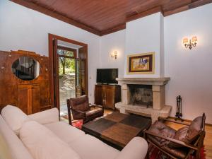 a living room with a couch and a fireplace at Casas de Massinos in Barroselas