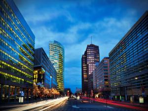 a city street with tall buildings and cars at Grand Hyatt Berlin in Berlin