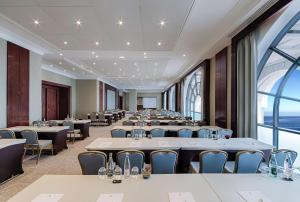 a conference room with tables and chairs and a large window at Hyatt Regency Nice Palais de la Méditerranée in Nice