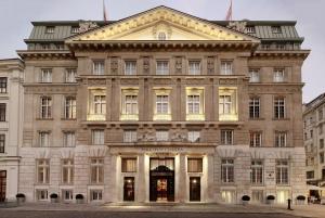 a large building in a city with lights on at Park Hyatt Vienna in Vienna