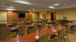 a conference room with tables and chairs and a tv at Hyatt Place Memphis Germantown in Memphis