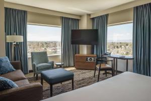 a hotel room with a bed and a flat screen tv at Hyatt Regency Aurora-Denver Conference Center in Aurora