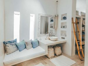 
a room with a white couch and a white sink at Cloud Nine Estate in Ubud
