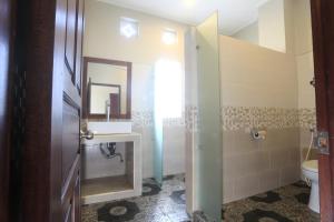 a bathroom with a sink and a toilet at Rama House in Ubud