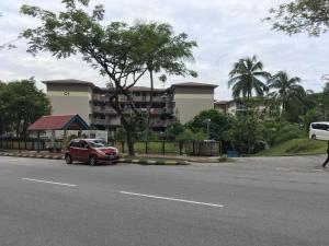 a red car parked on the side of a street at Homestay Farah Wangsa Maju KL in Kuala Lumpur