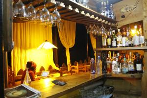 a bar with a lot of bottles of wine at Altai Oasis Lodge in Sorata