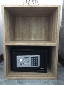 a microwave in a wooden box with a drawer at Marisa Garden Bungalow in Bang Tao Beach