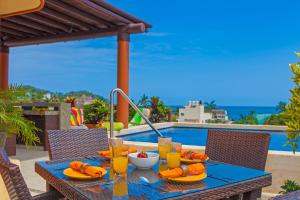 a table with food and drinks on it next to a pool at Beach Break Suites Sayulita in Sayulita