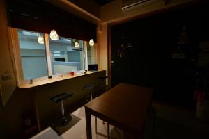 a dark room with a table and a window at K2 Hostel in Taitung City