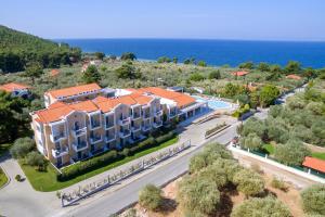 an aerial view of a building with the ocean in the background at Louloudis Boutique Hotel in Skala Rachoniou