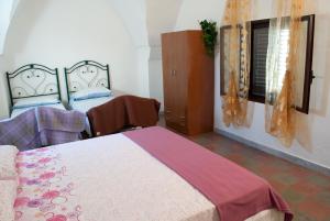 Postel nebo postele na pokoji v ubytování Masseria Lama D'impisa