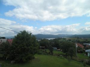 a view of a town with trees and a lake at Pod Kabajka in Polańczyk