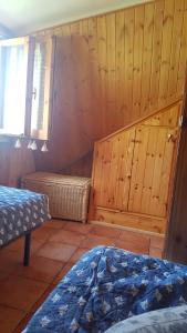 a room with two beds and a window at Fiocco di Neve in Massa dʼAlbe