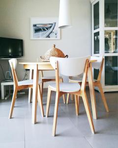 a dining room table with a white chair and a table and chairsktop at Avia Holiday Homes in Avía +43 photos