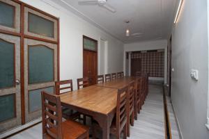 a conference room with a wooden table and chairs at Elysium Ecotel in Jaipur