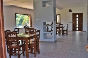 a dining room with a table and chairs at Heaven Guesthouse in Corbeni