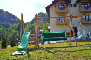 a playground in front of a house at Heaven Guesthouse in Corbeni