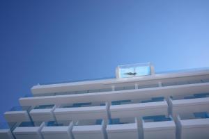 a white building with a white roof and a blue sky at Iberostar Bahía de Palma - Adults Only in Playa de Palma