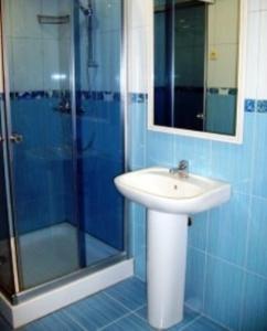 a bathroom with a sink and a shower at Hotel Complex Gayki in Zhytomyr