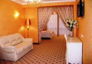 a living room with a couch and a table at Hotel Complex Gayki in Zhytomyr