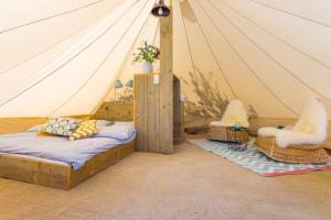 A bed or beds in a room at Boutique Camping Nono Ban