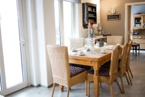 a dining room with a wooden table and chairs at Hotel Restaurant Am Kellhof in Singen