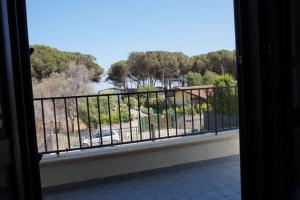 a room with a balcony with a view of a park at Lvresidence Roccelletta in Catanzaro Lido