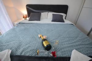 a bedroom with a bed with a bottle on it at Apartment VUKOTA Zlatibor in Zlatibor