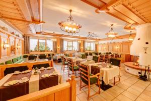 a restaurant with tables and chairs in a room at Chalet Oberstdorf in Oberstdorf +6 photos