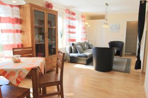 a living room with a table and a couch at Ferienwohnung Seerose mit Terrasse in Sassnitz