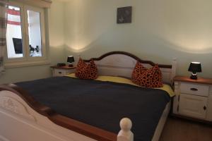 a bedroom with a bed with leopard pillows on it at Ferienwohnung Seerose mit Terrasse in Sassnitz