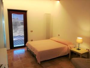 Postel nebo postele na pokoji v ubytování Agriturismo Forestale Luti
