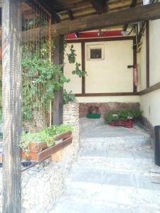 a courtyard with a stone wall and benches at Hotel Vivat in Velikodolinskoye