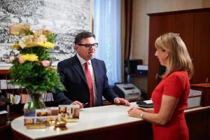 a man and a woman standing at a desk at Hotel Austria - Wien in Vienna