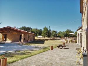 a patio with a picnic table and a building at Agriturismo Forestale Luti in Treia