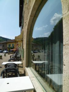 a view of tables and chairs from a window at L'embellie in Treffort