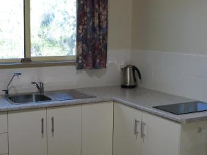 
a kitchen with a stove top oven and a window at Watervale Retreat in Watervale
