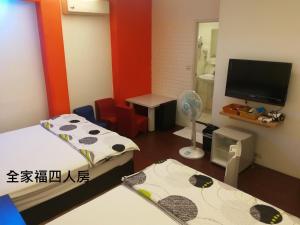 Habitación pequeña con 2 camas y TV de pantalla plana. en Yes 17, en Luodong