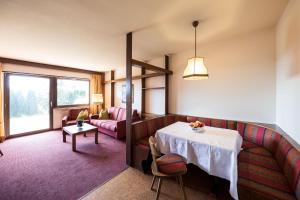 a living room with a table and a couch at Apartments Feyerlin in Lana