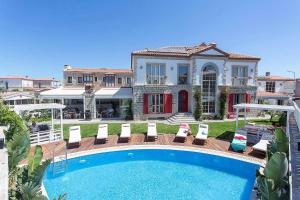 a house with a swimming pool in front of a house at Kokopelli Alacati in Alaçatı