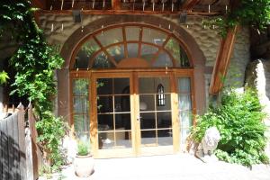 a large glass door of a building with a cat sitting in front at Weinloft Staufen in Staufen im Breisgau