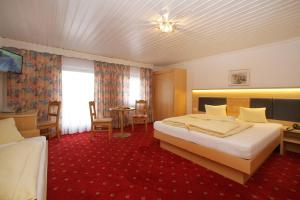 מיטה או מיטות בחדר ב-Altachhof Hotel und Ferienanlage