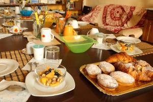 a table topped with plates of food and pastries at Palazzo Barba in Gallipoli