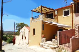 a house with a balcony on top of it at Villa Galanthus in Lístaros