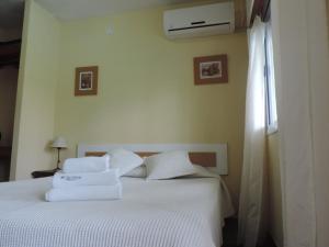 Una cama o camas en una habitación de Casa Di Aqua Apart Hotel