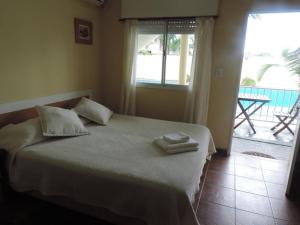 Una cama o camas en una habitación de Casa Di Aqua Apart Hotel