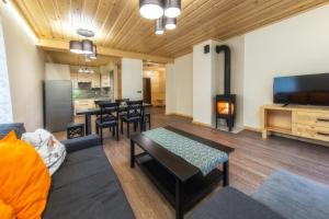 salon ze stołem i kominkiem w obiekcie Apartamenty 58 Czarny Groń w mieście Rzyki
